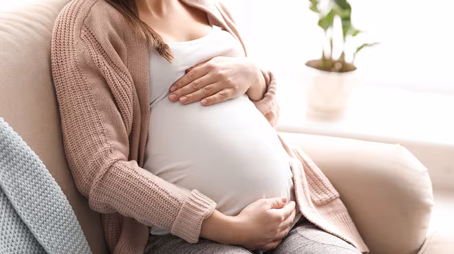 pregnant woman holding baby bump